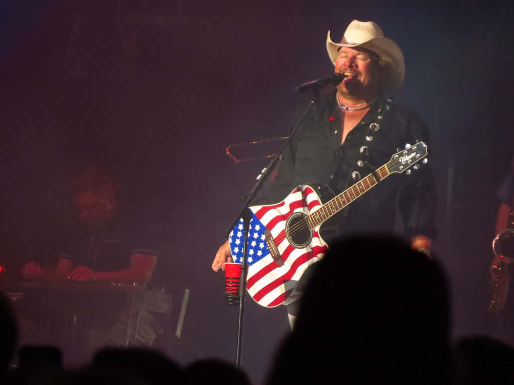 Toby Keith American Flag Guitar Performance Wallpaper