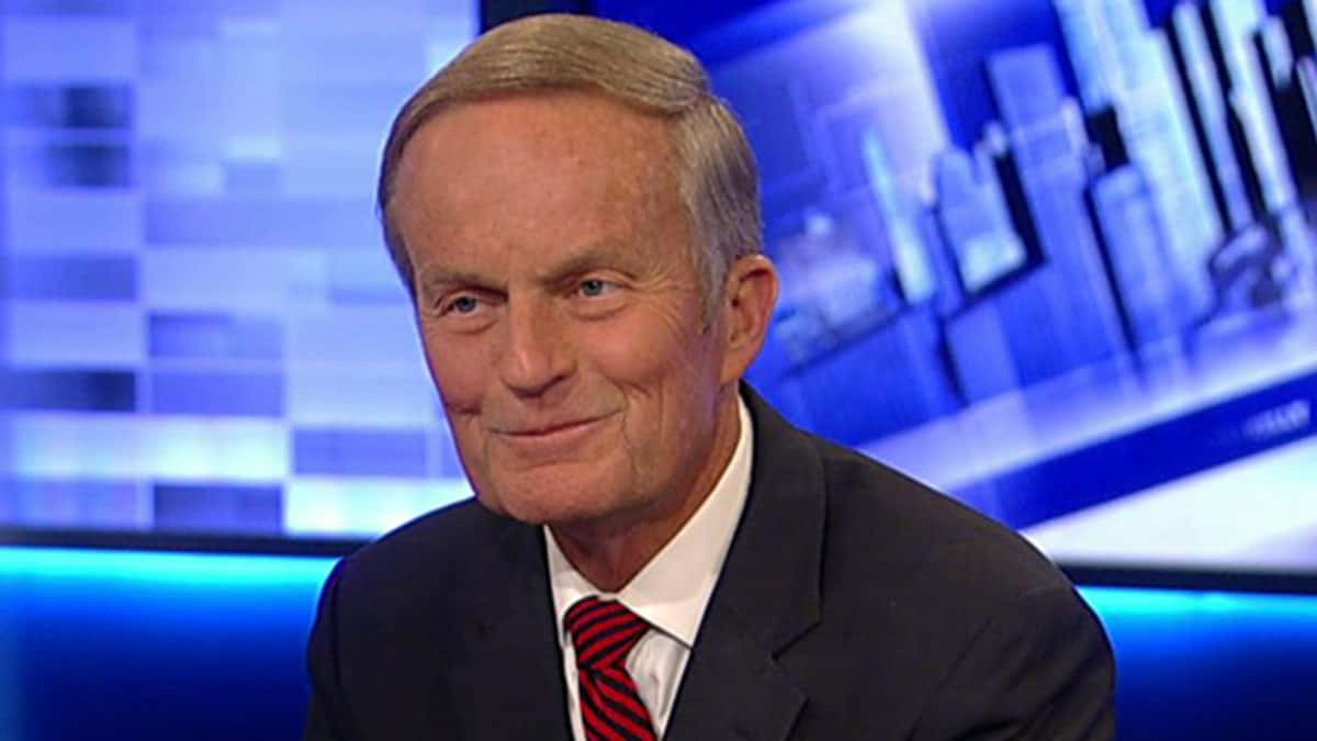 Todd Akin Standing Against A Building Background Wallpaper