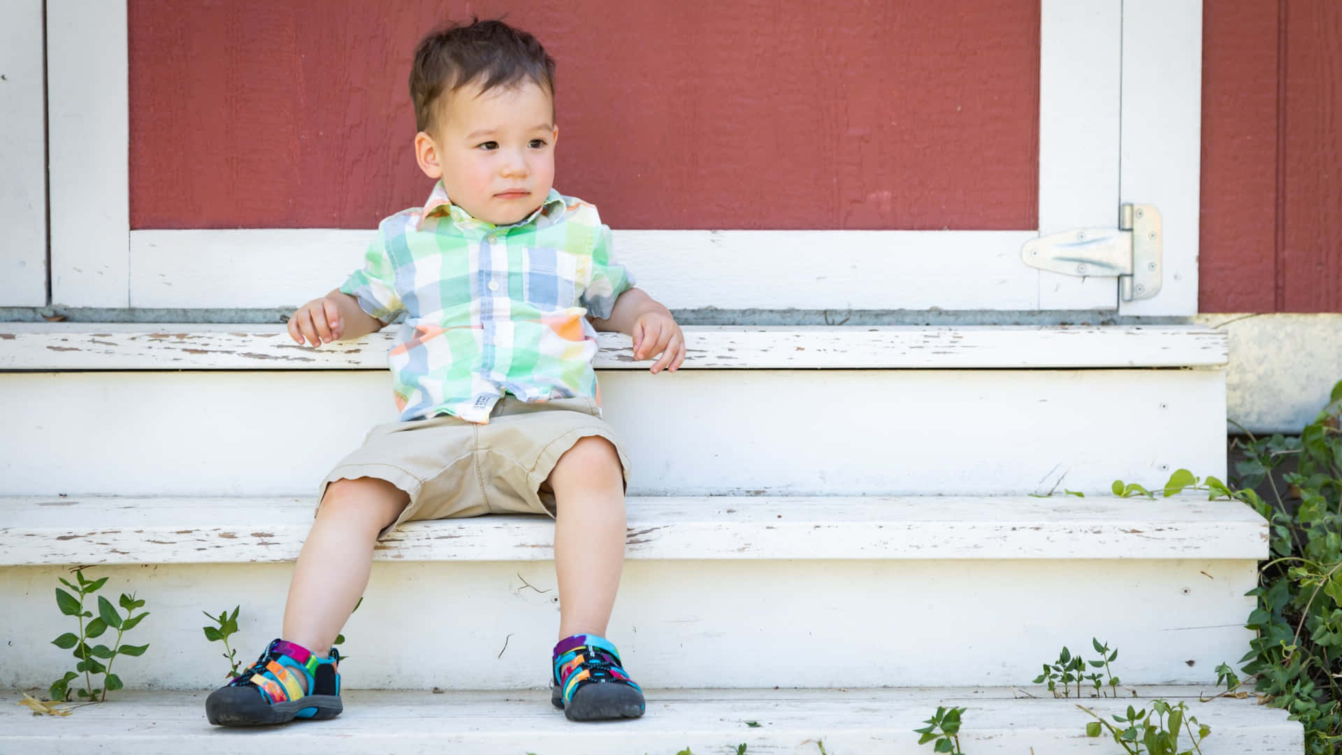 Toddler Sittingon Steps Outdoors Wallpaper