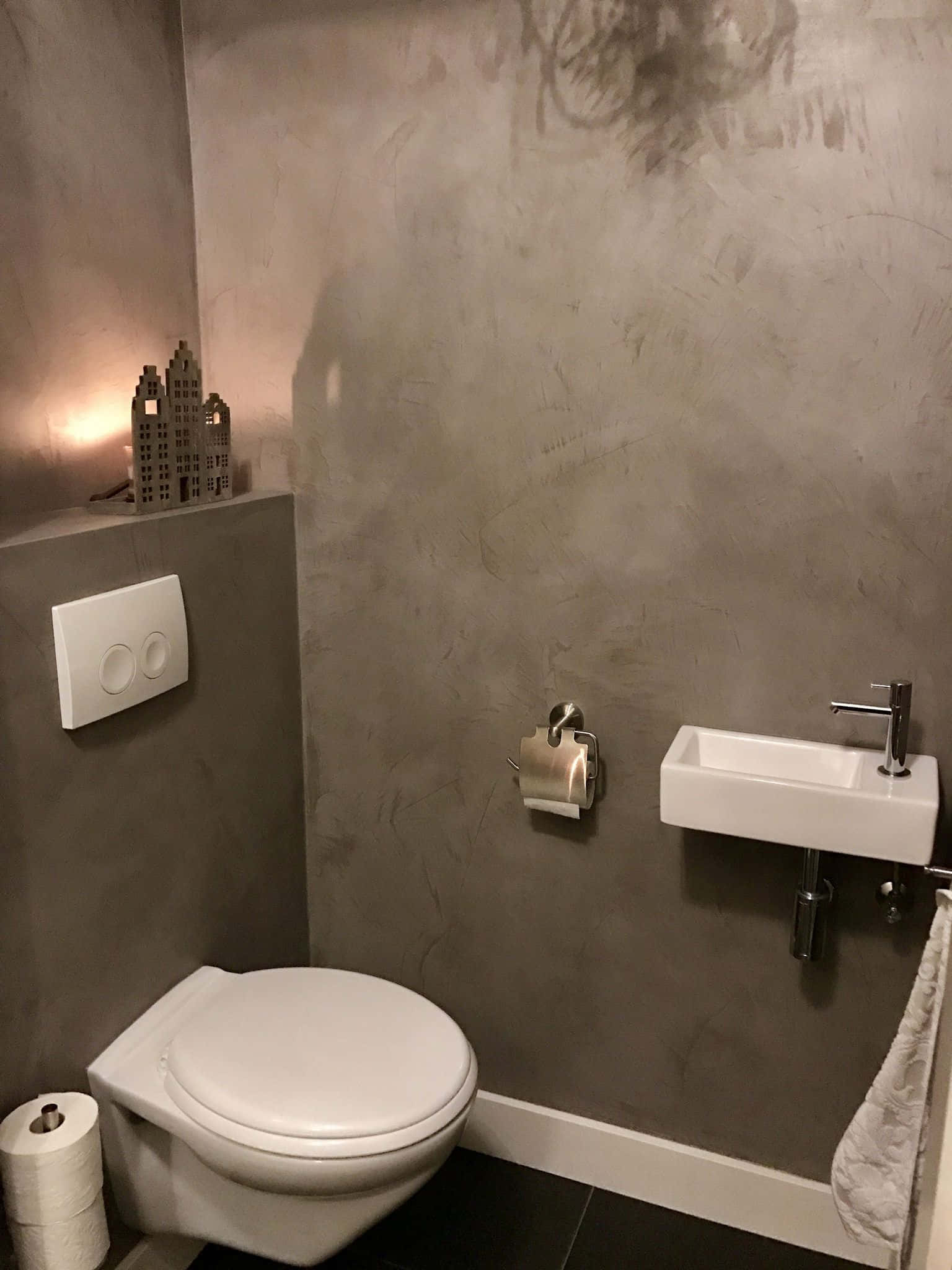 Modern ceramic toilet in a simple minimalist bathroom