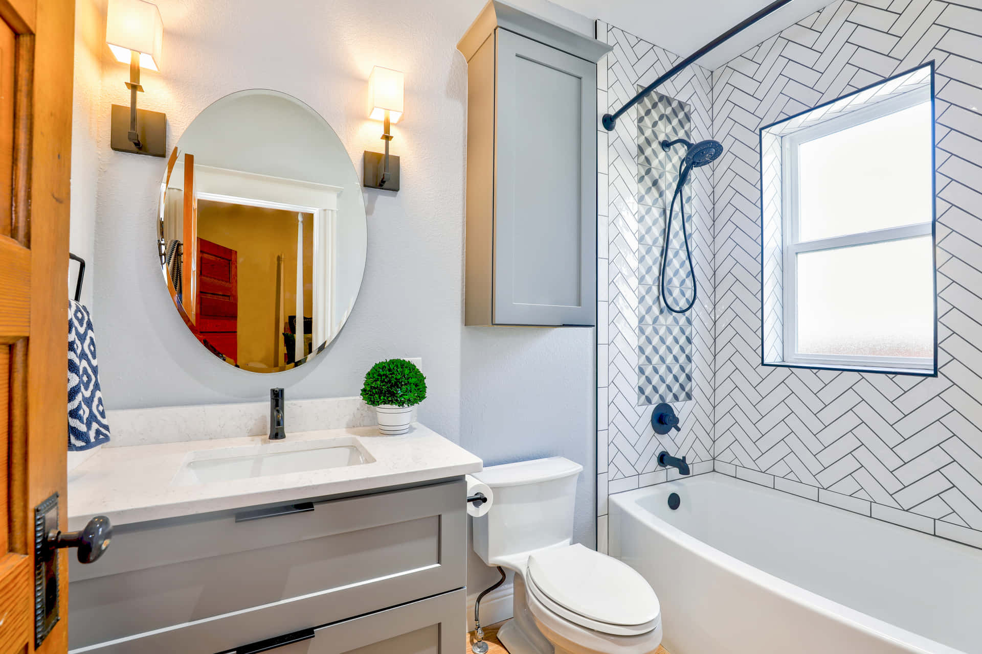A Bathroom With A White Sink And White Tile