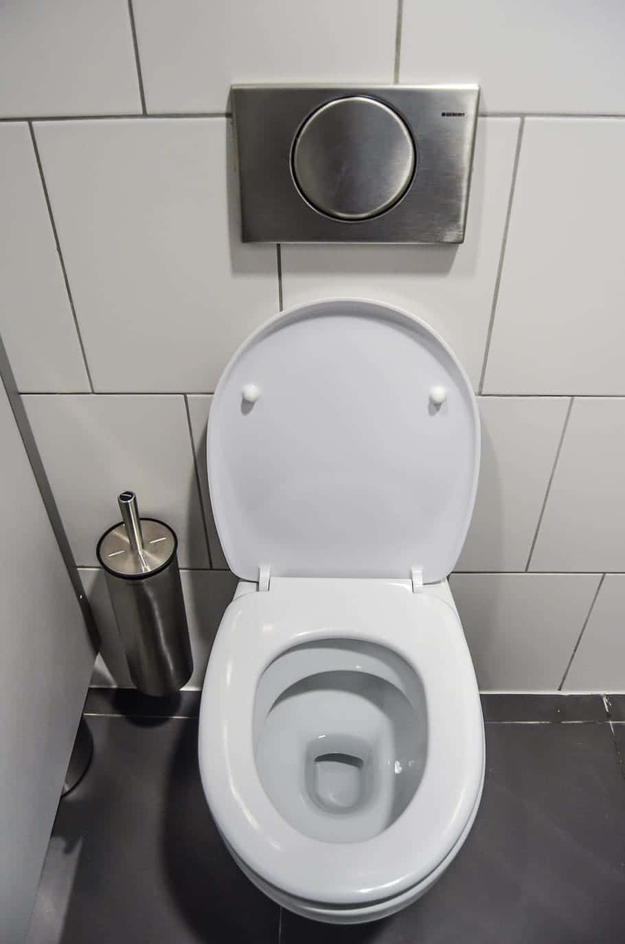 A Toilet In A Bathroom With A Seat Open