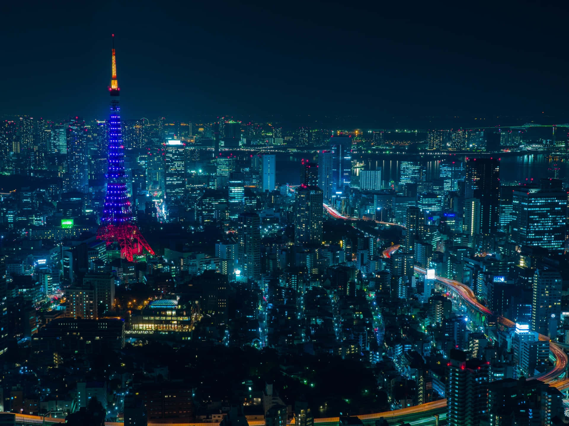 Fondode Pantalla De Tokyo Con Luces De La Ciudad Por La Noche