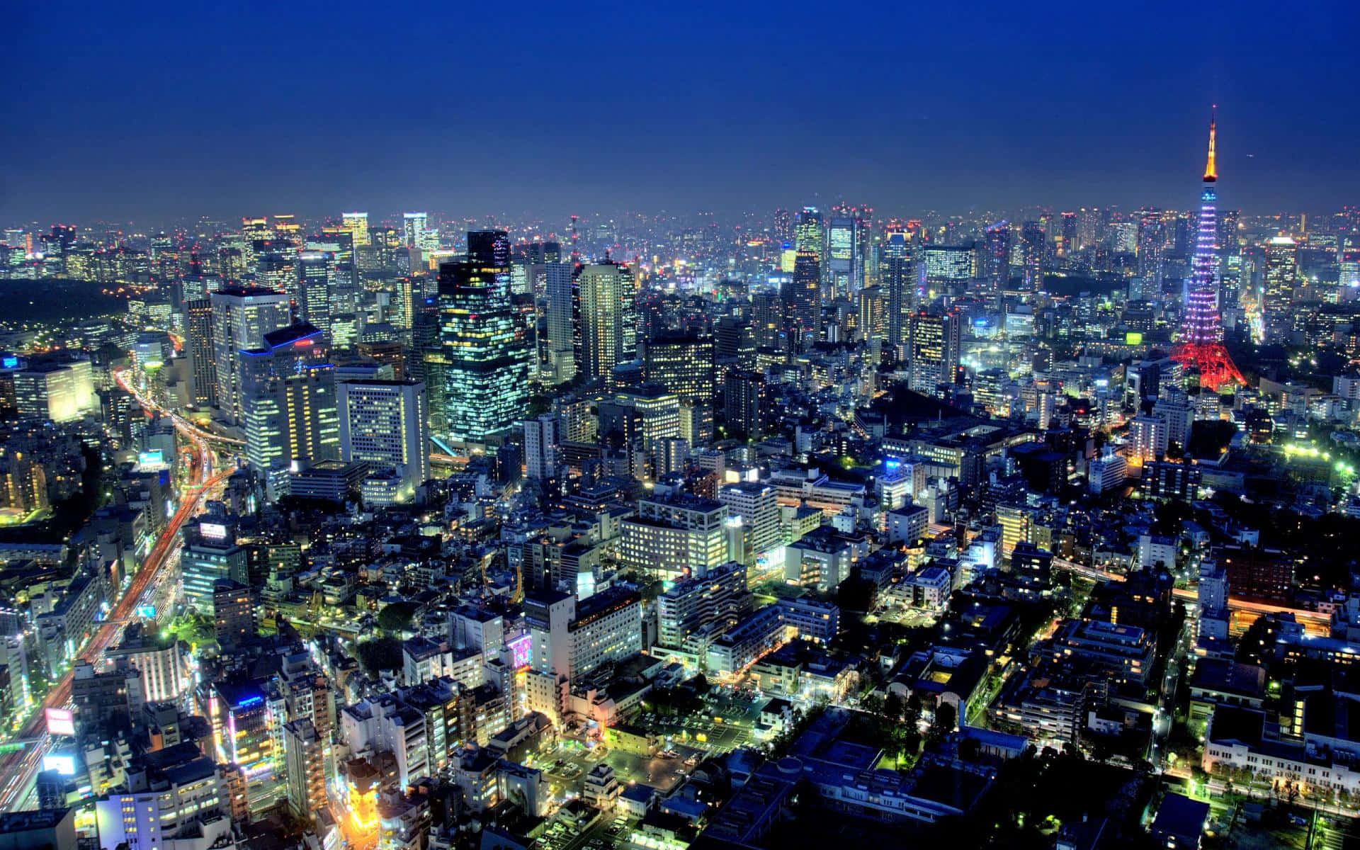 Fondode Pantalla De Tokyo Con Brillantes Luces De La Ciudad.