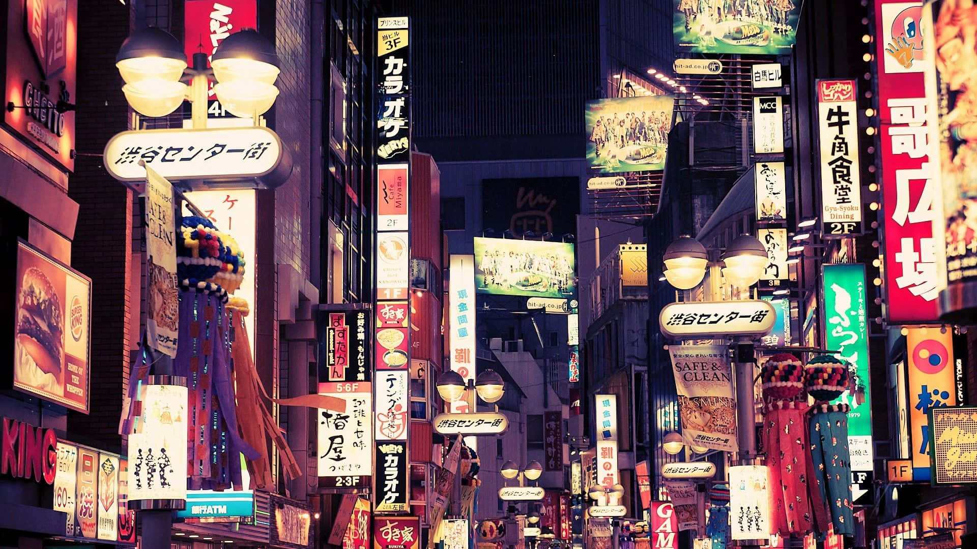 Fondode Pantalla De Tokio Con Brillantes Letreros De Calles.