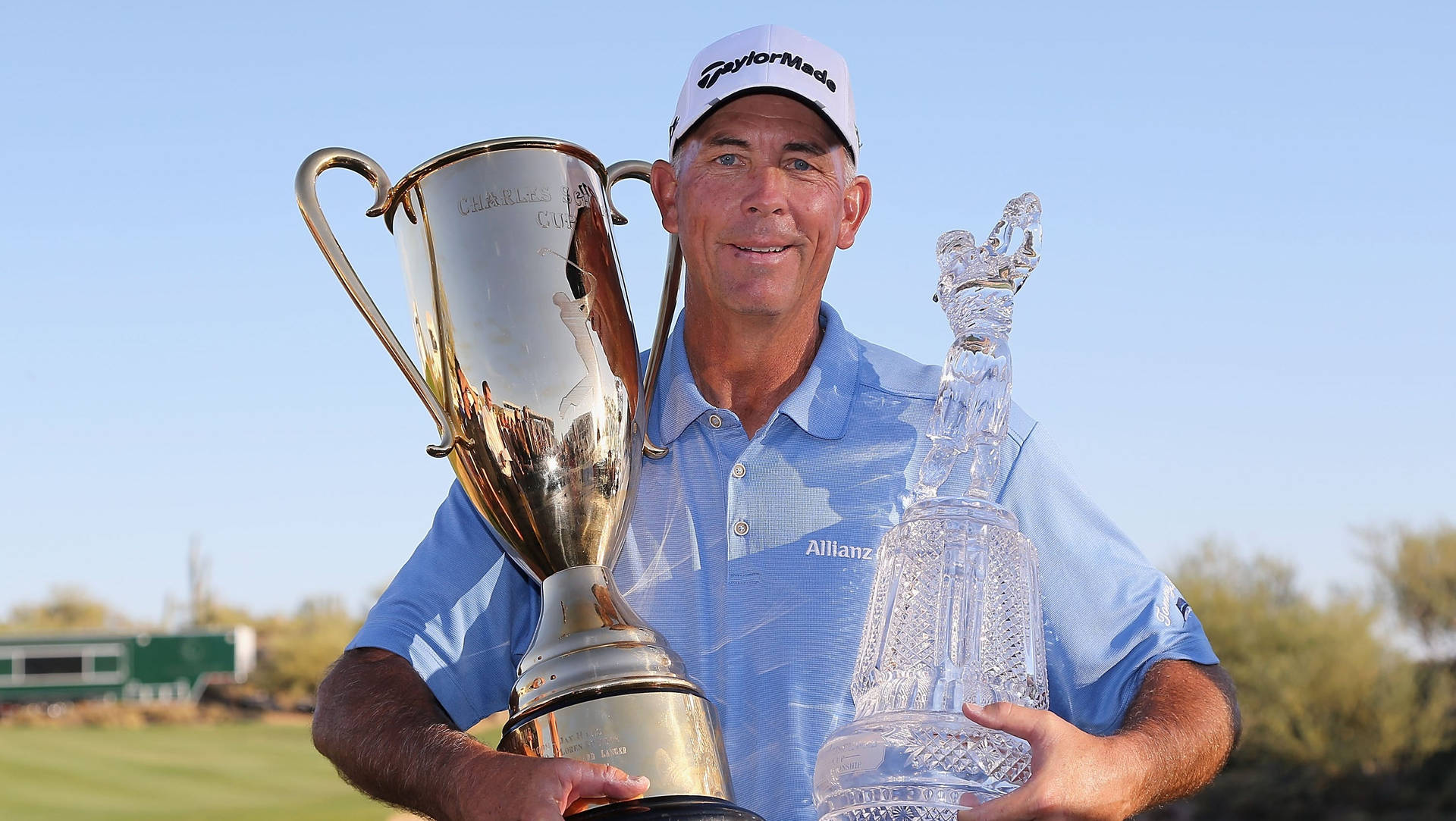 Tom Lehman Celebrating Victory with Two Trophies Wallpaper