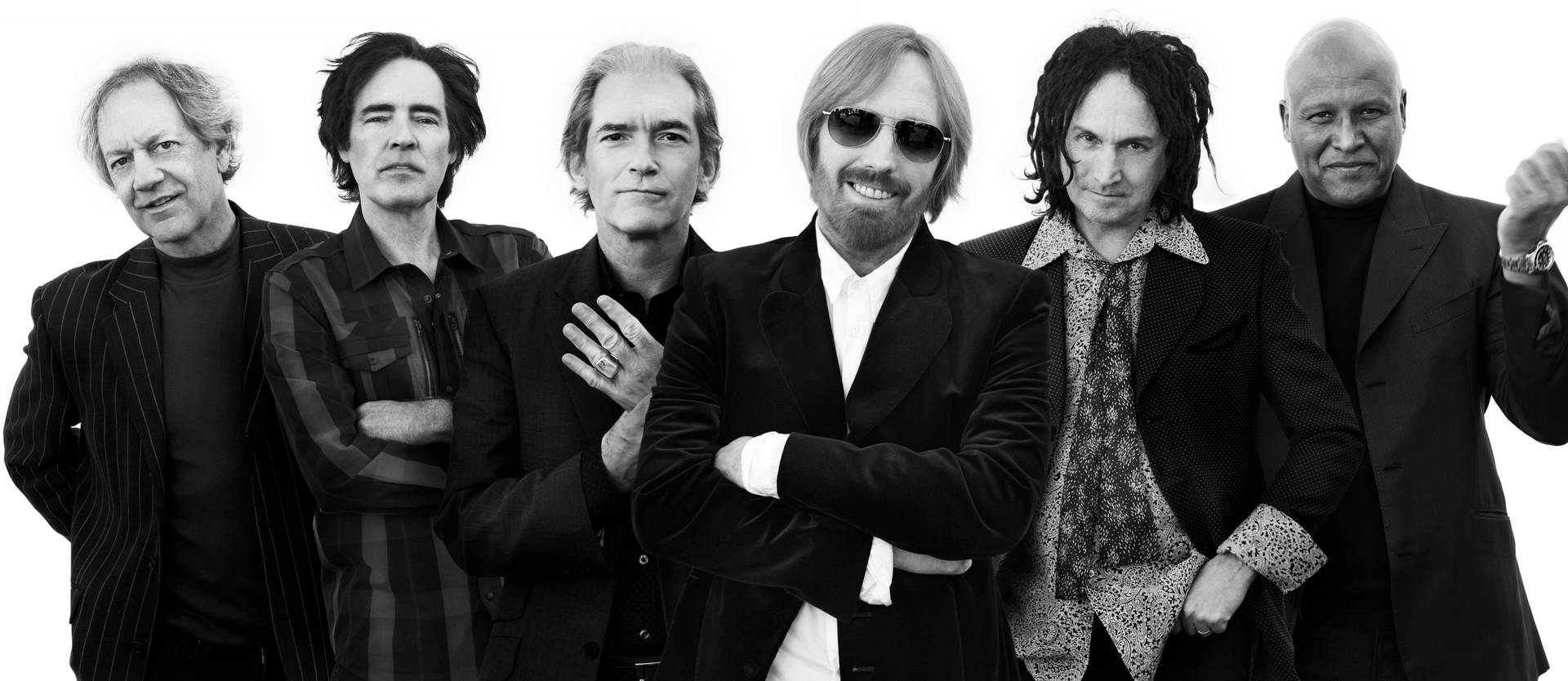 Iconic Tom Petty And The Heartbreakers electrifying concert moment. Wallpaper