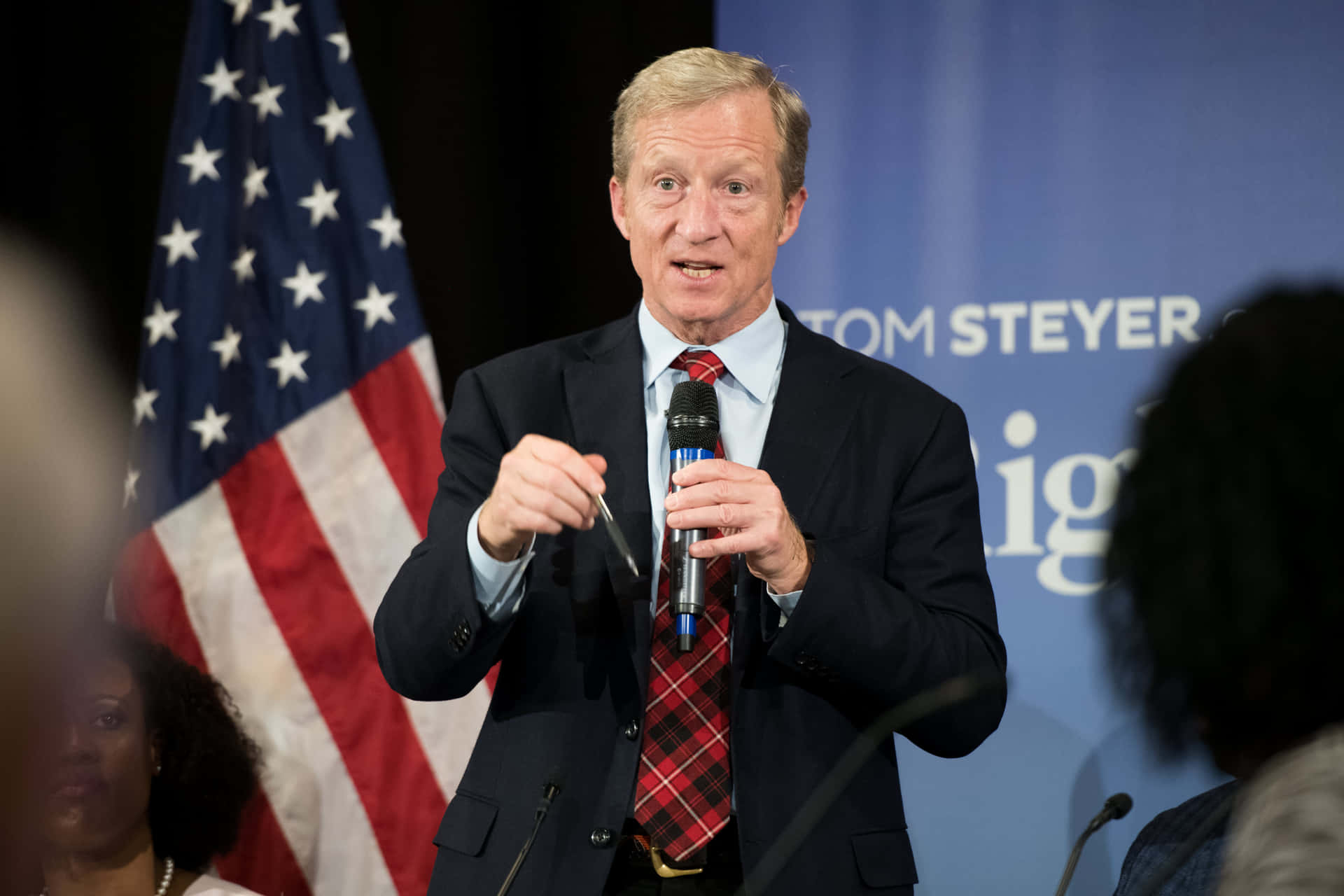 Tom Steyer Holding A Microphone Wallpaper