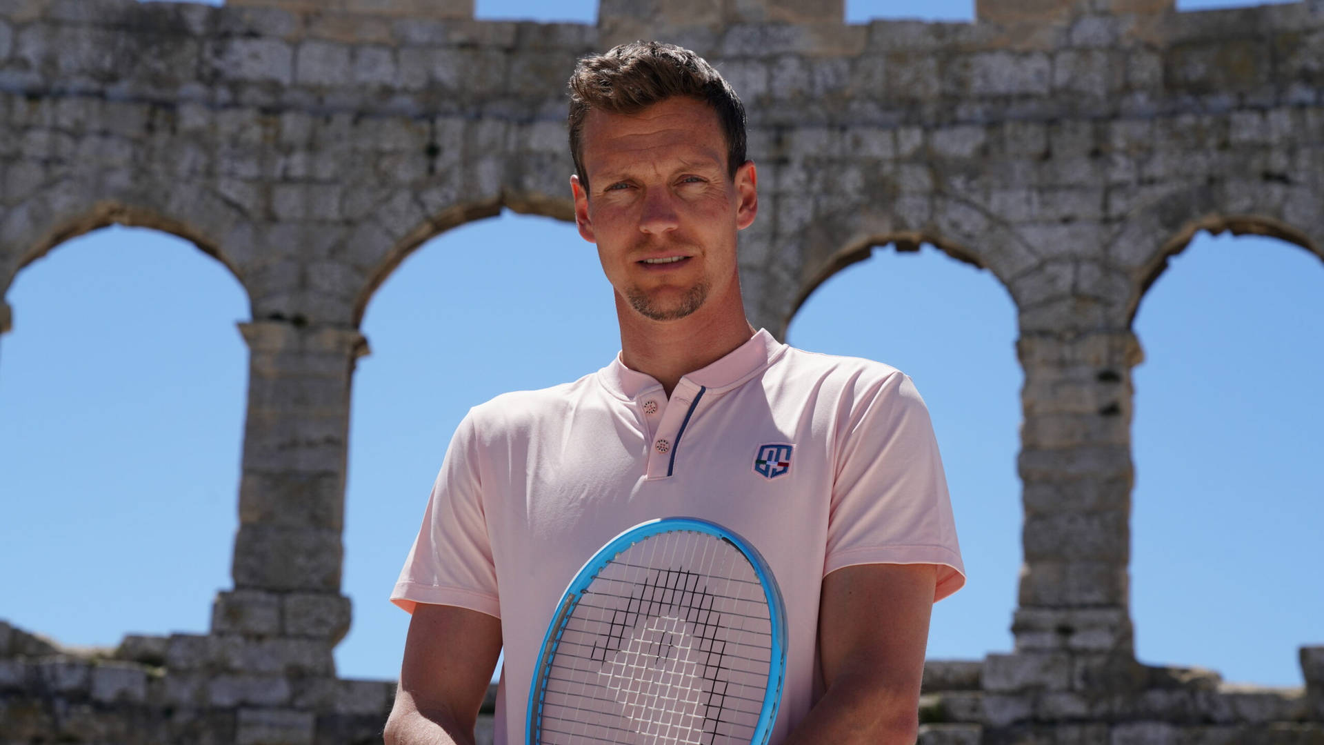 Tennis star Tomas Berdych against an old stone wall backdrop. Wallpaper