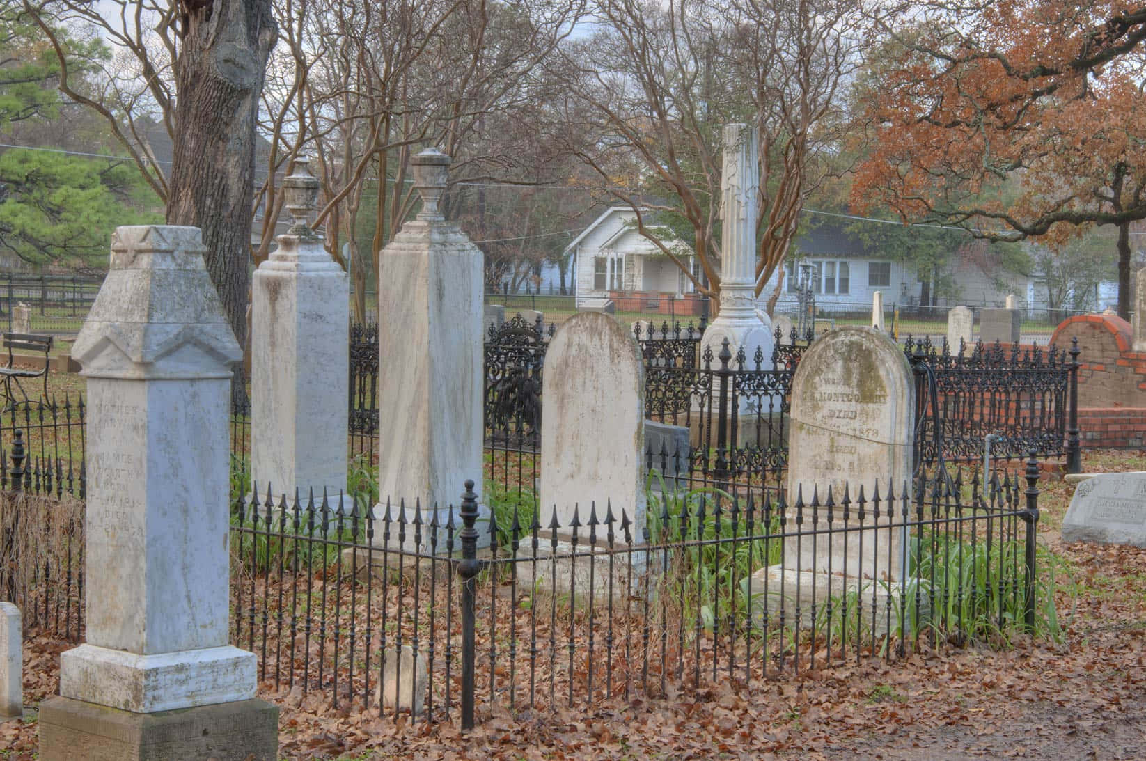 A Cemetery With Many Tombstones And A Fence
