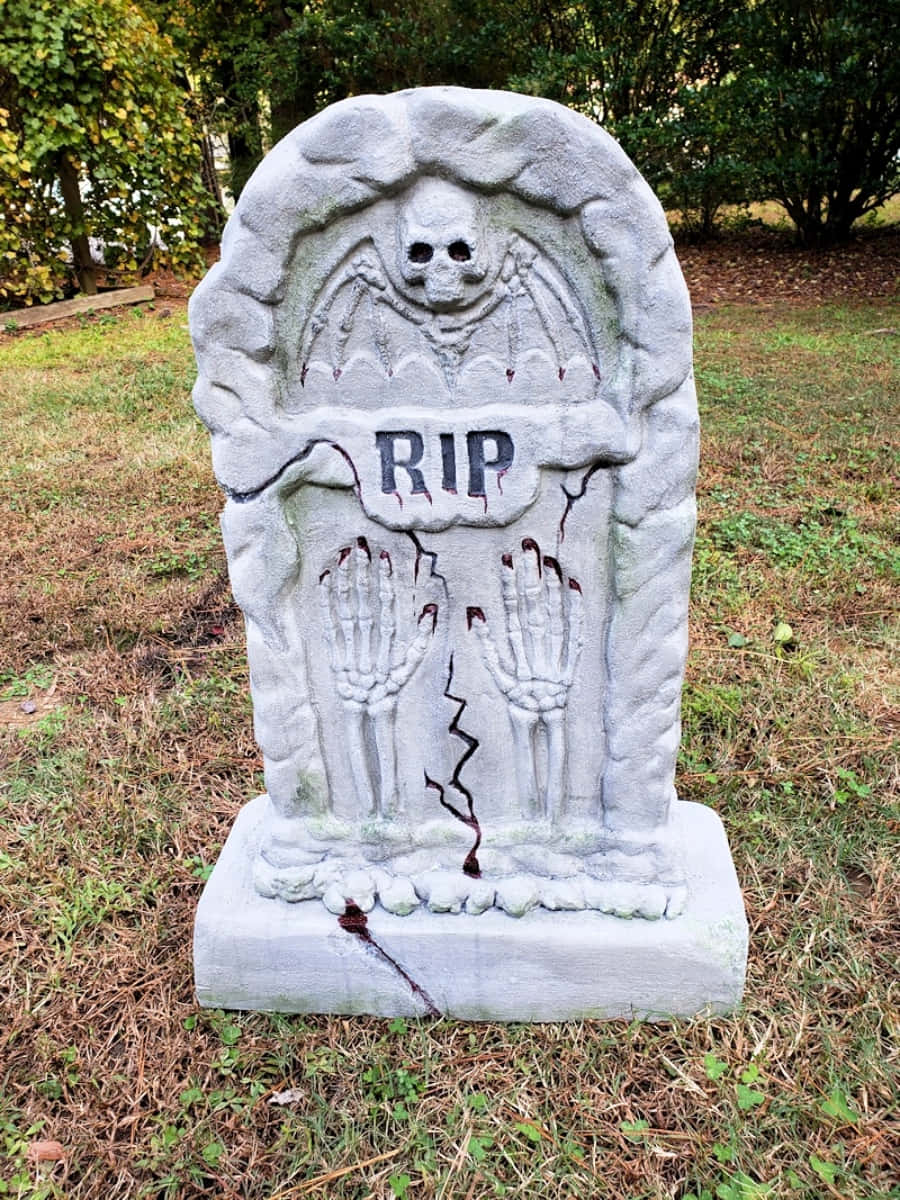 A Gravestone With A Skull And A Rip On It