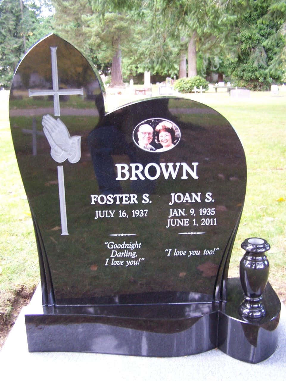 A Gravestone With The Name Brown And A Cross