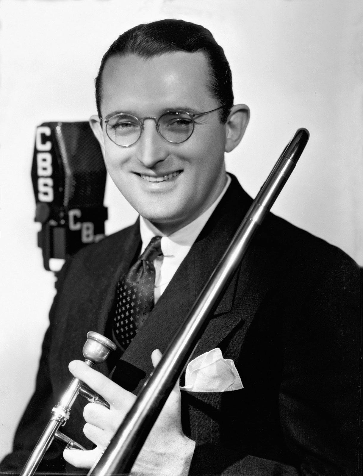 Tommy Dorsey's engaging smile in a black and white portrait Wallpaper