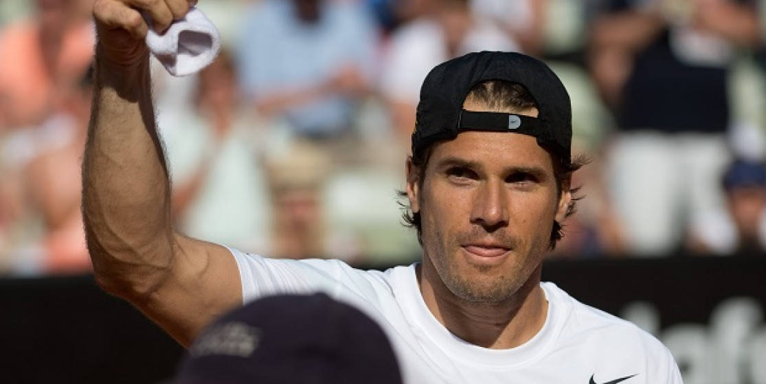Tommy Haas Holding Up Cloth Wallpaper