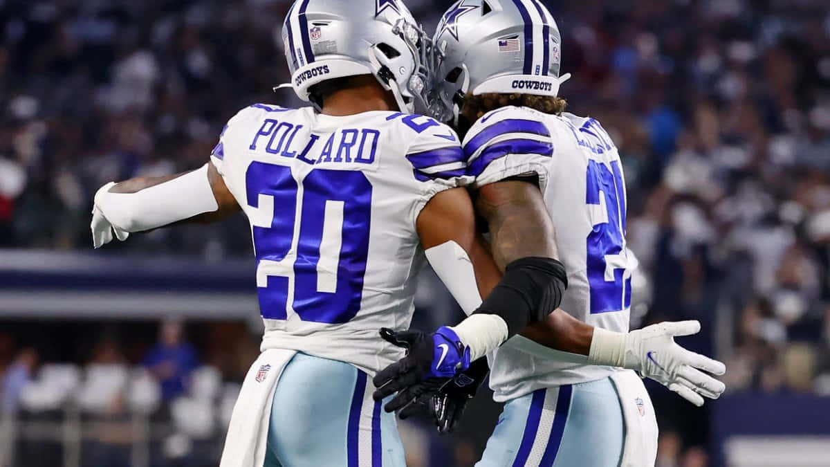 Tony Pollard Celebratingwith Teammate Dallas Cowboys Wallpaper