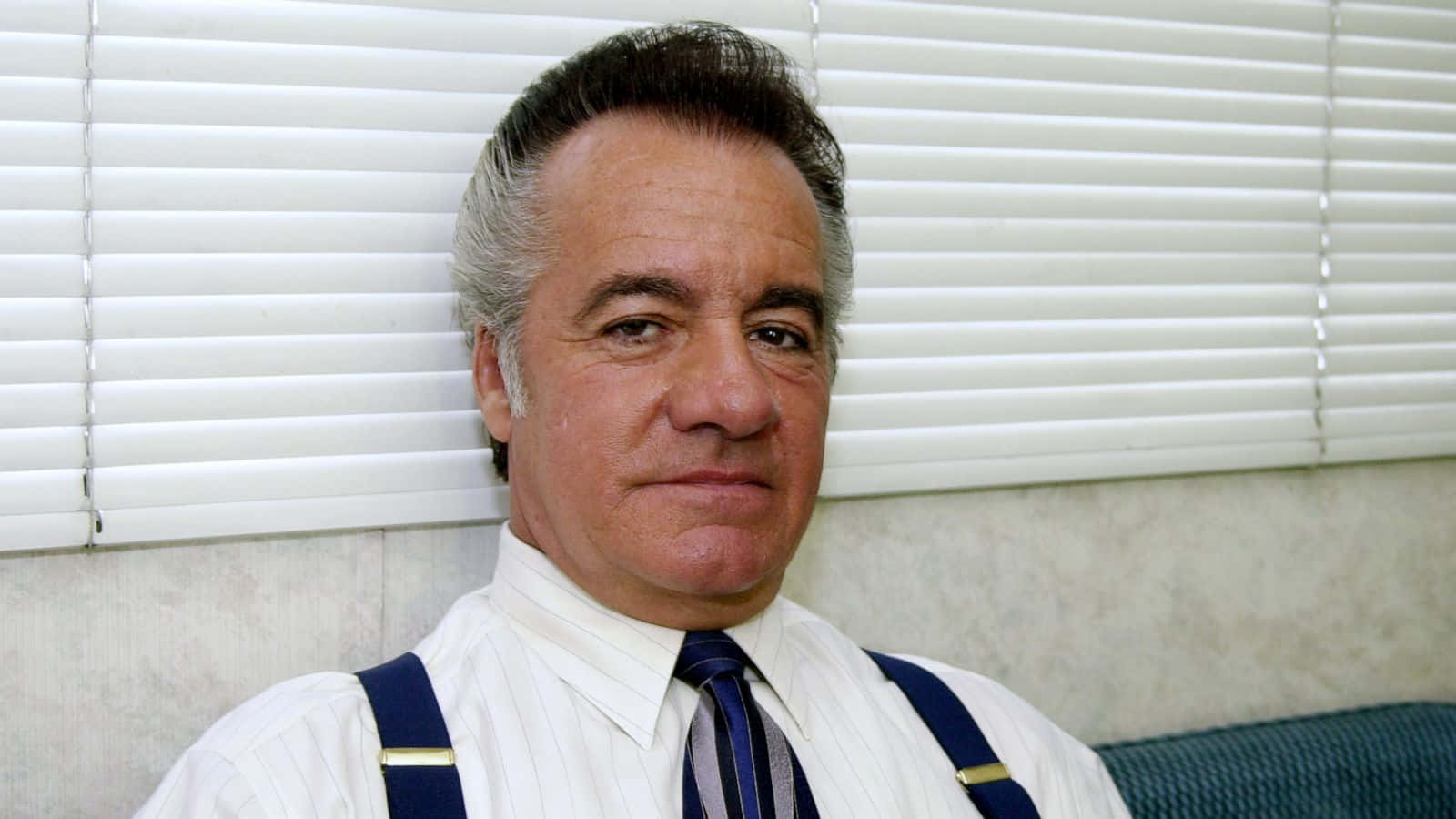 Tony Sirico, a legendary actor from The Sopranos, with a compelling gaze. Wallpaper