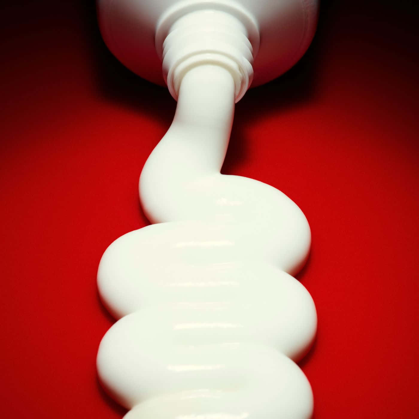 Download Toothpaste_ Squeeze_ Closeup_ Red_ Background.jpg Wallpaper