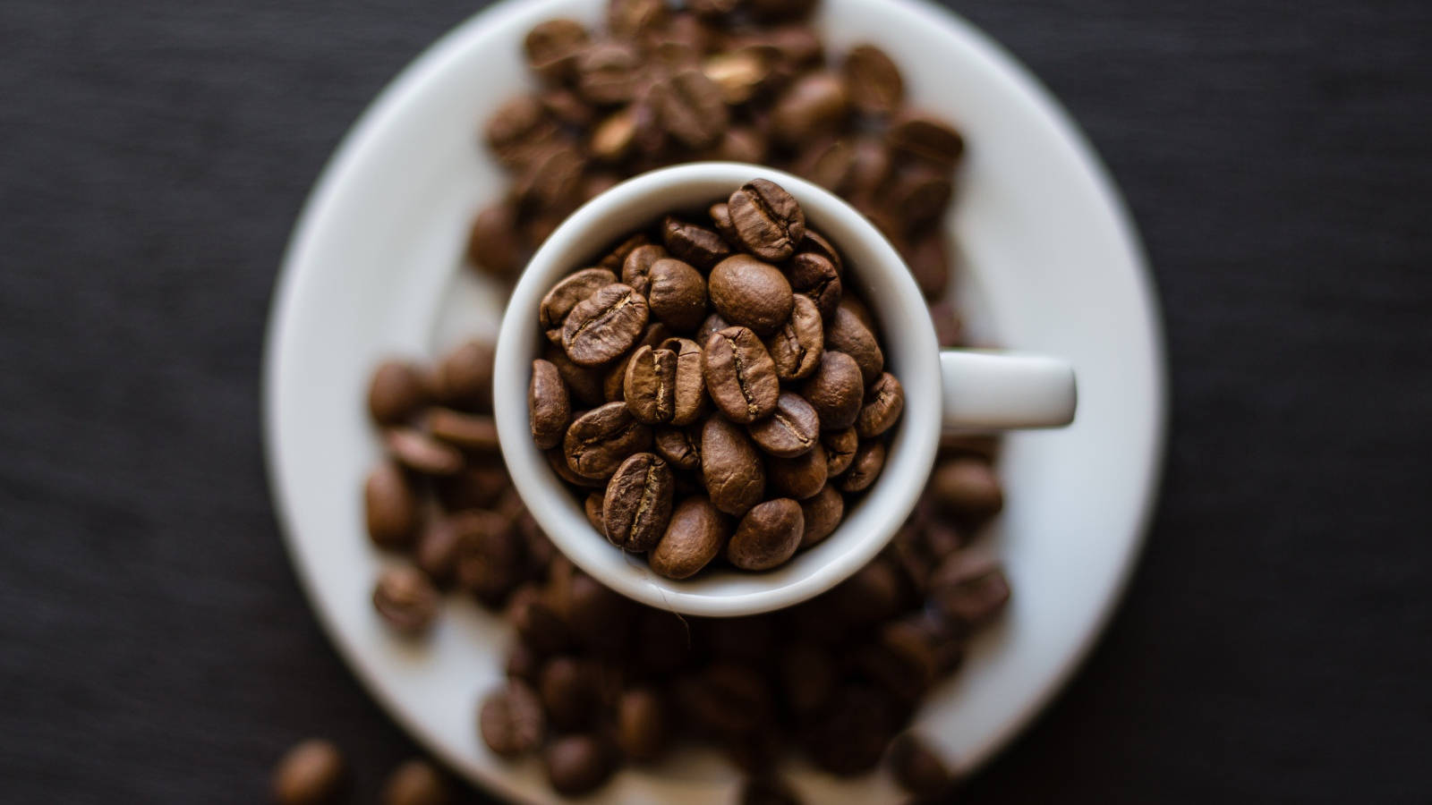 Top View Of Coffee Cup With Coffee Beans Wallpaper