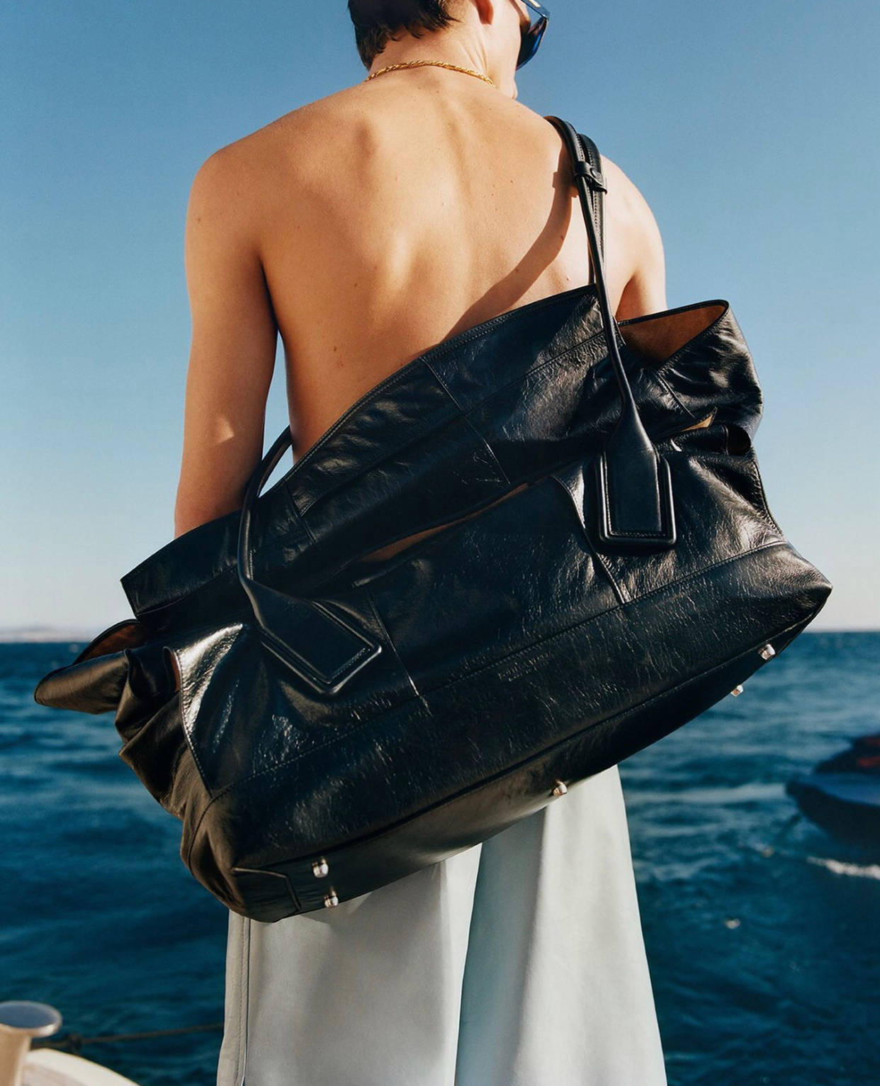 Topless Model With Black Bottega Veneta Bag Background