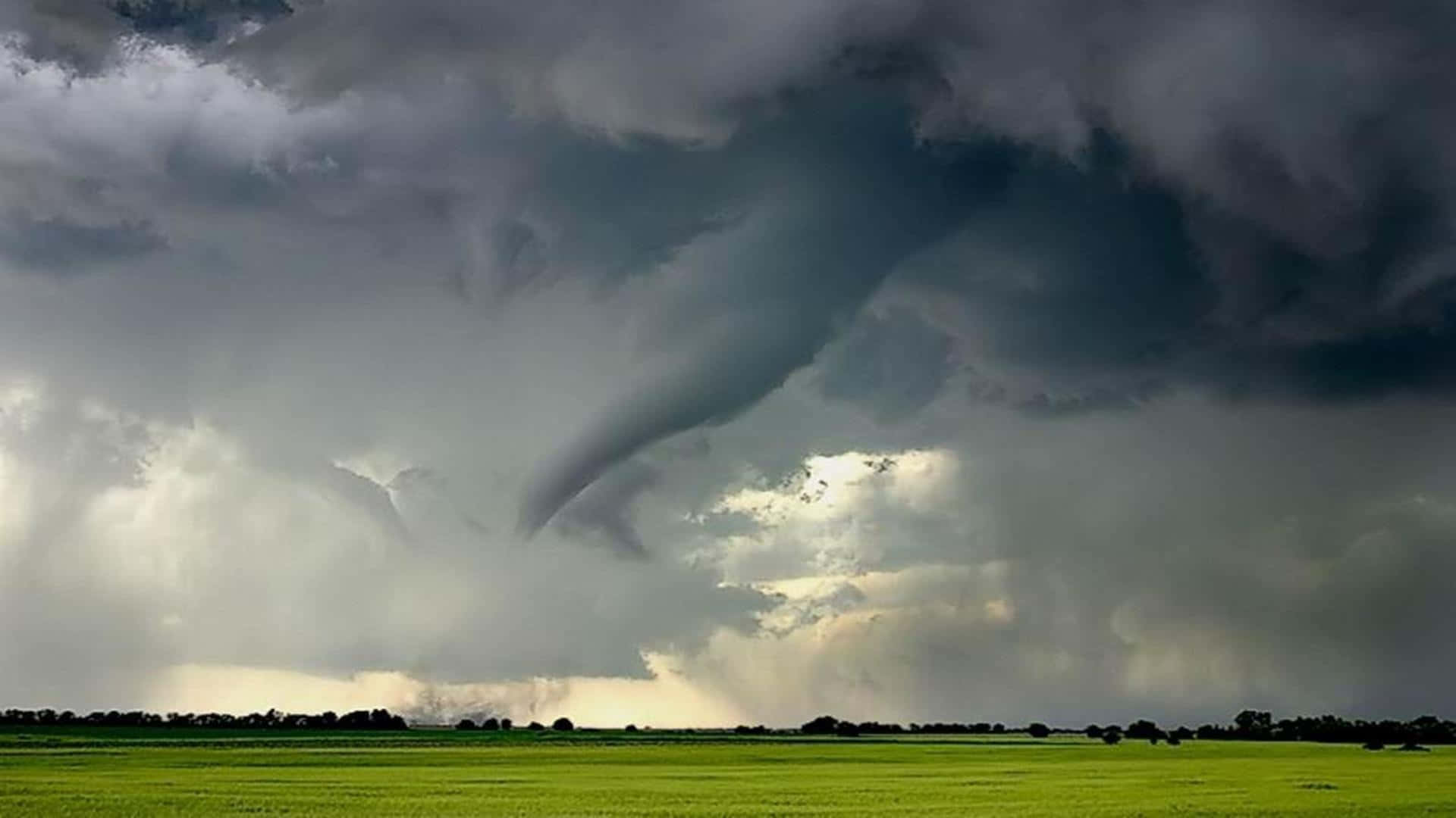 A powerful tornado sweeps across the vast open landscape