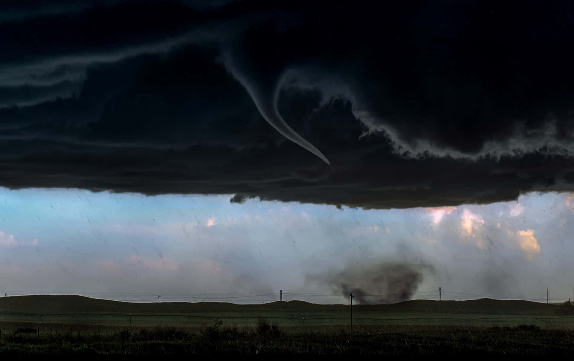 A powerful tornado sweeping across the vast landscape