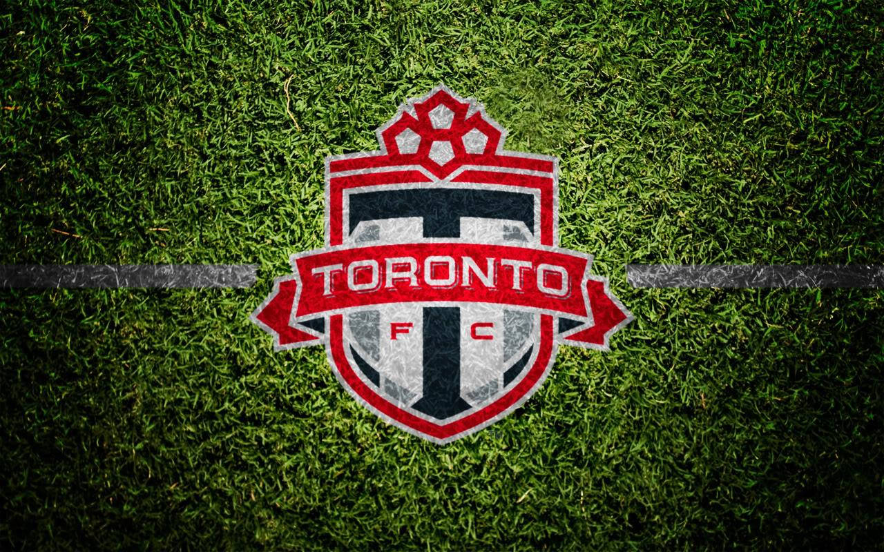 Download The official logo of Toronto FC emblazoned in vibrant red.  Wallpaper