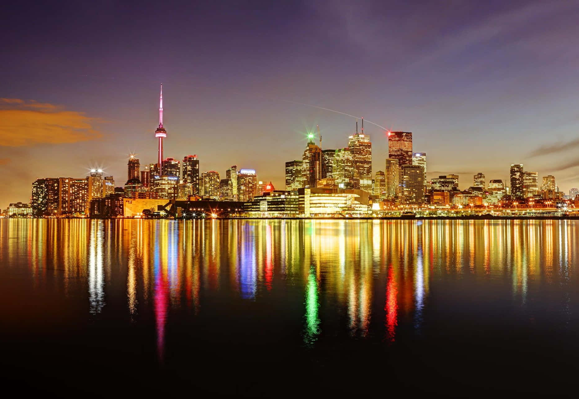 Toronto Skyline At Night With Colorful Lights Reflecting In The Water