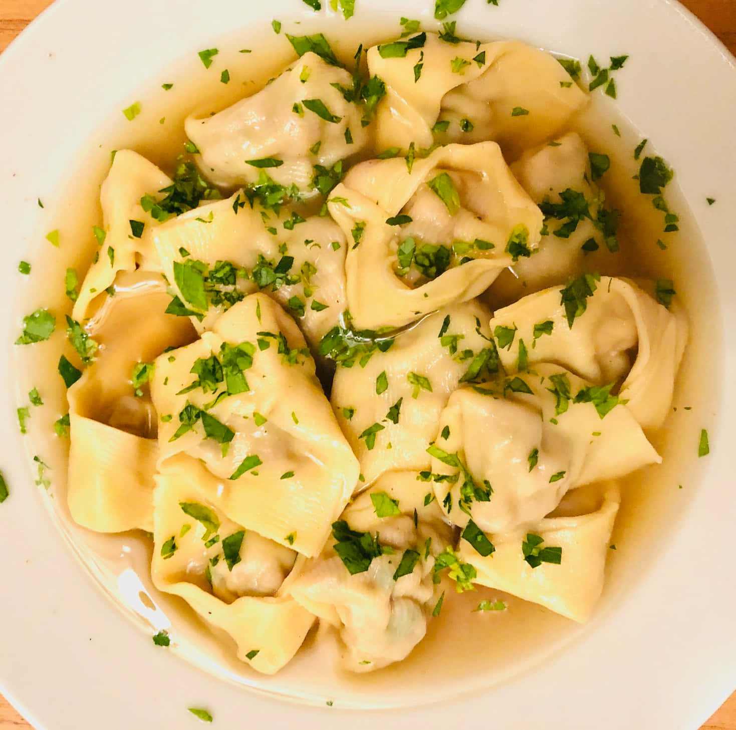 Authentic Tortellini in Brodo garnished with Fresh Greens Wallpaper