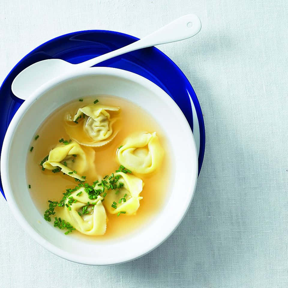 Tortellini In Brodo With Sprinkled Green Onions Wallpaper