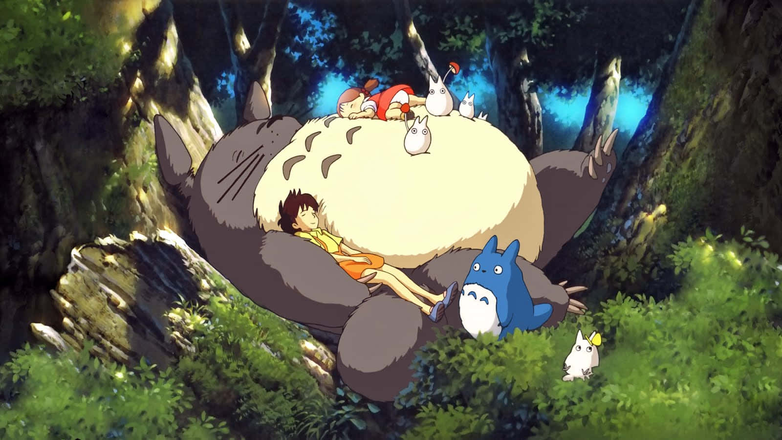 A Group Of People Sitting On Top Of A Giant Totoro