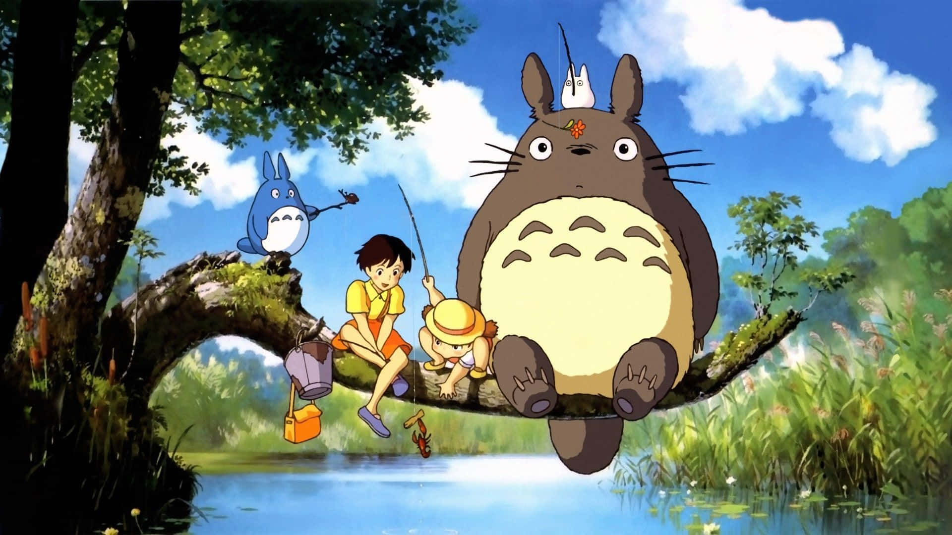 Einegruppe Von Totoro-charakteren Sitzt Auf Einem Ast. Wallpaper