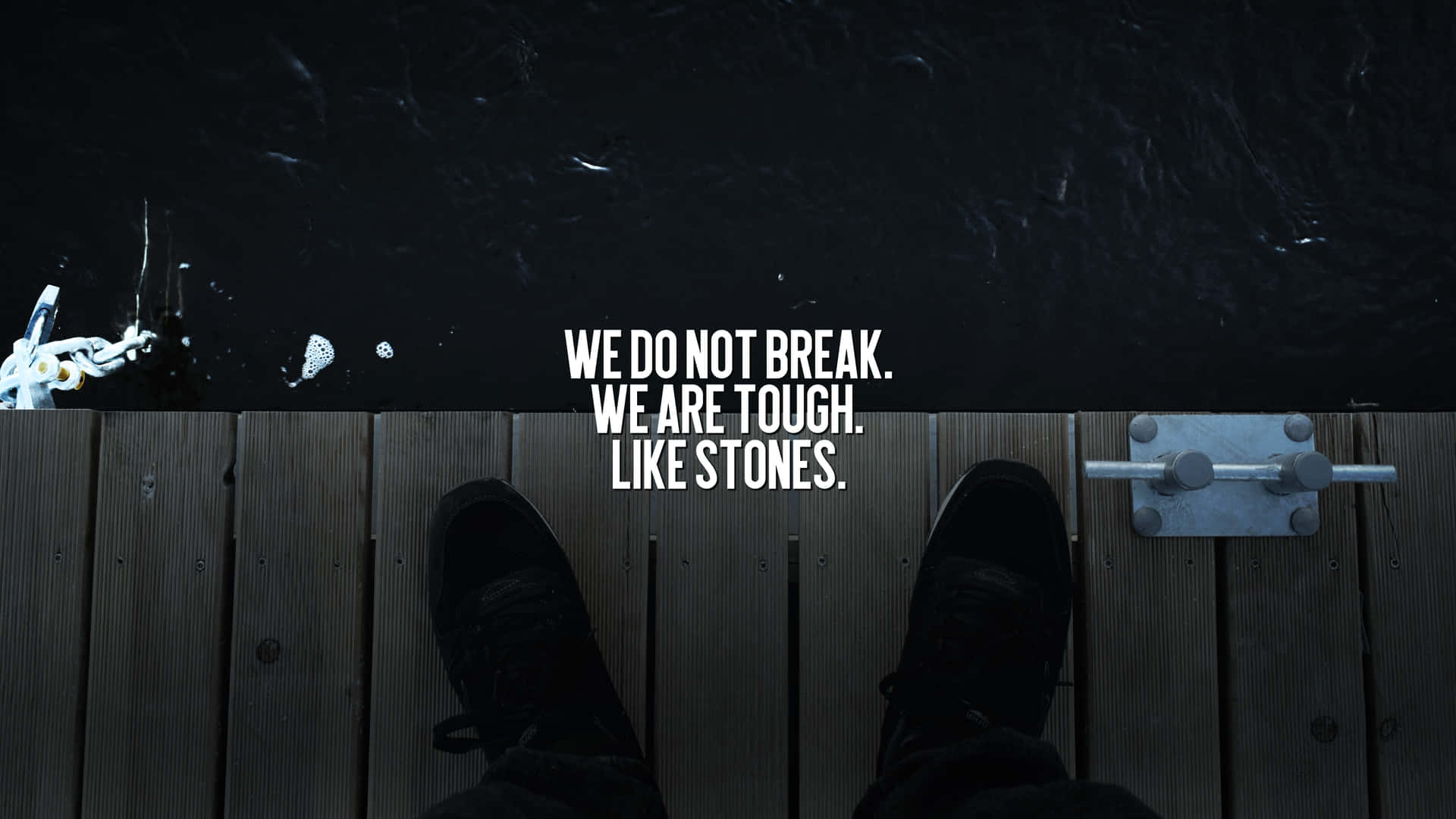 A Person Standing On A Dock With The Words We Don't Break We Are Tough Life's Stones Wallpaper