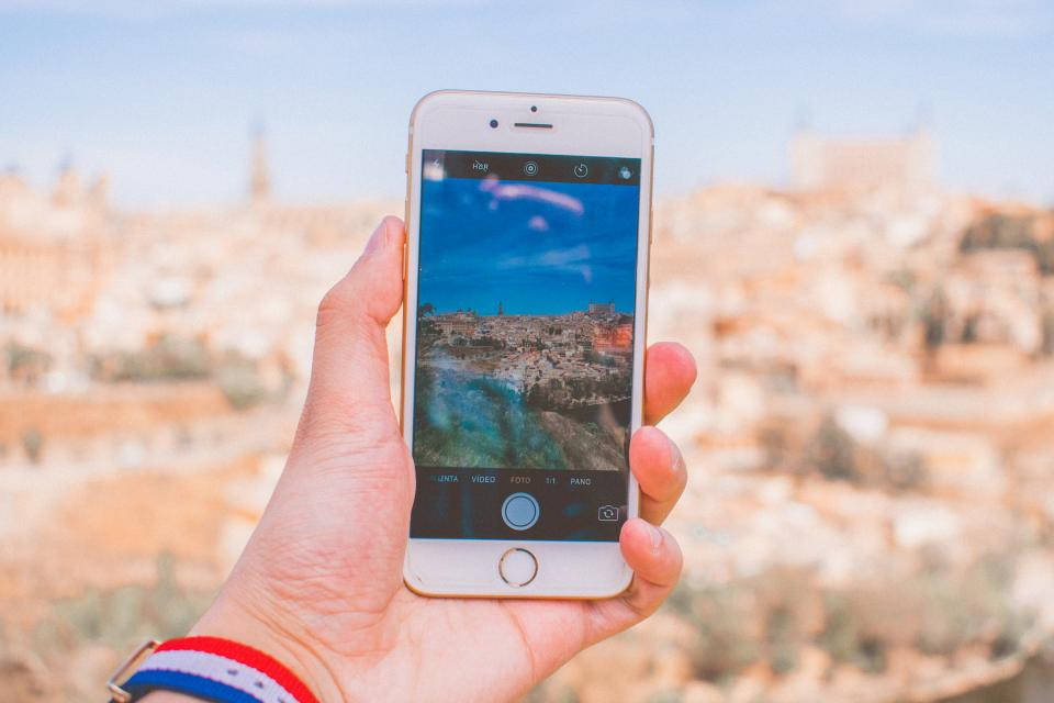 Tourist Doing Photography Via Iphone Wallpaper