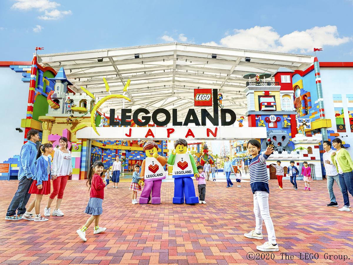 Tourists And Mascots At Legoland Japan Wallpaper