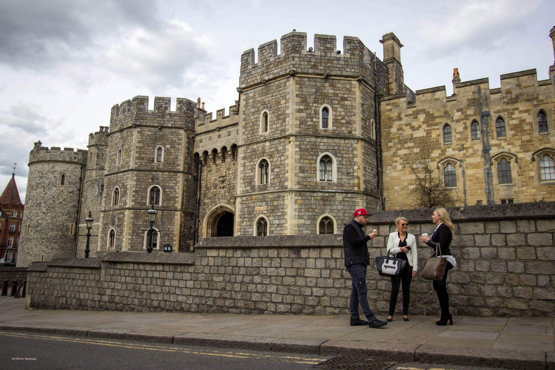 Caption: Majestic Windsor Castle Hosting Tourists Under an Overcast Sky. Wallpaper