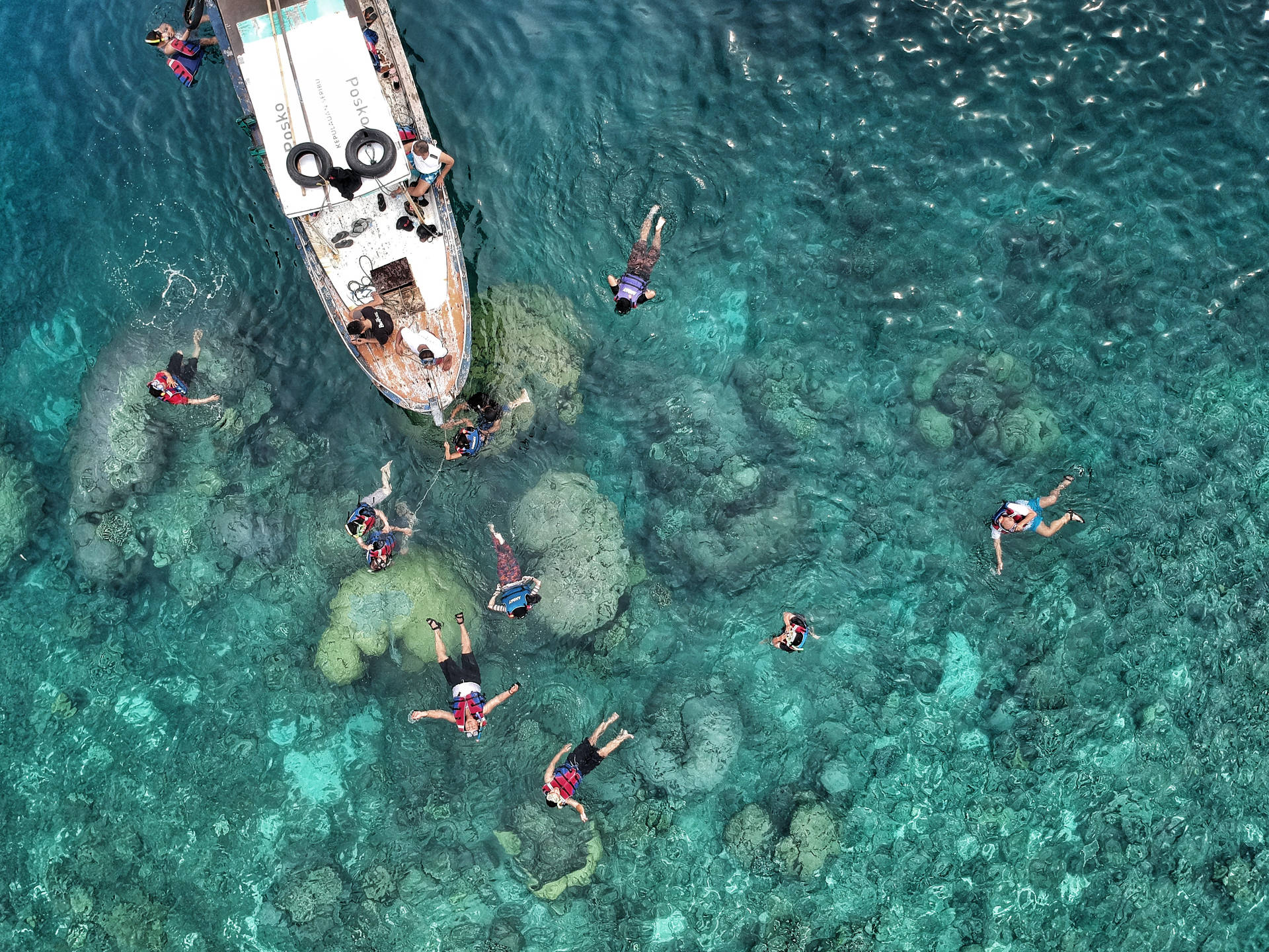 Tourists Snorkeling Near Boat Wallpaper