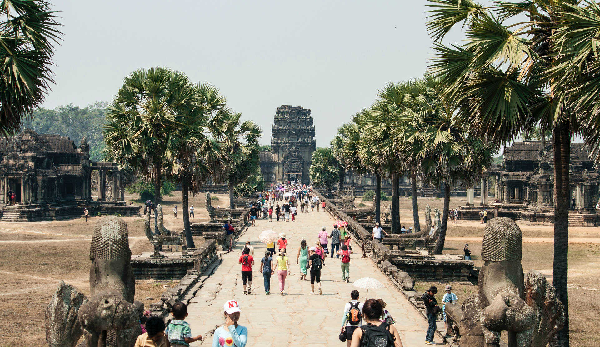 Tourists Walking Towards Angkor Wat Wallpaper