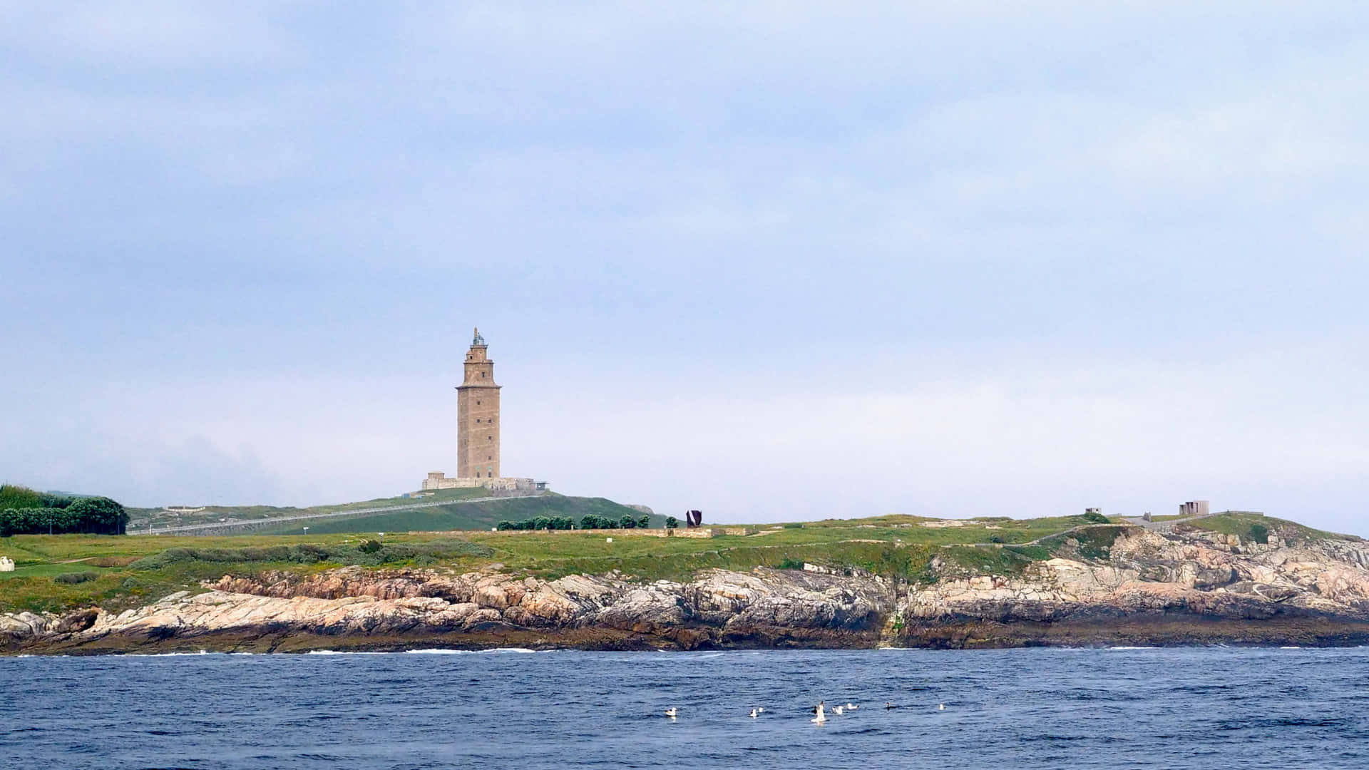 Tower Of Hercules Above The Ocean And Grass Wallpaper