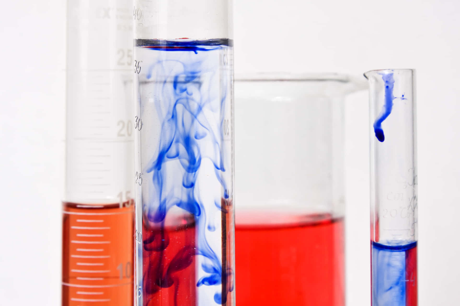 A Group Of Test Tubes With Blue And Red Liquids Wallpaper