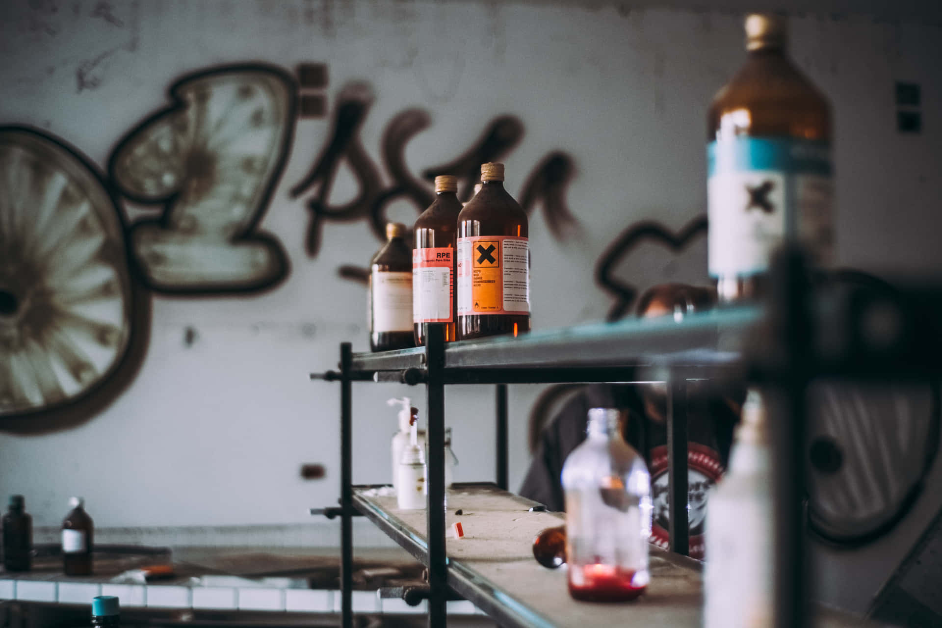 A Shelf With Bottles Of Alcohol And Graffiti Wallpaper