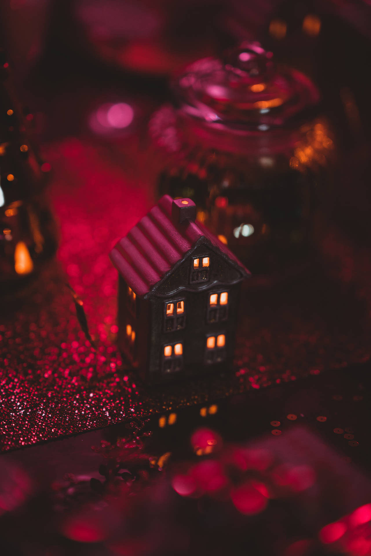 Celebrate Christmas with a cozy toy house adorned in red Christmas lights Wallpaper