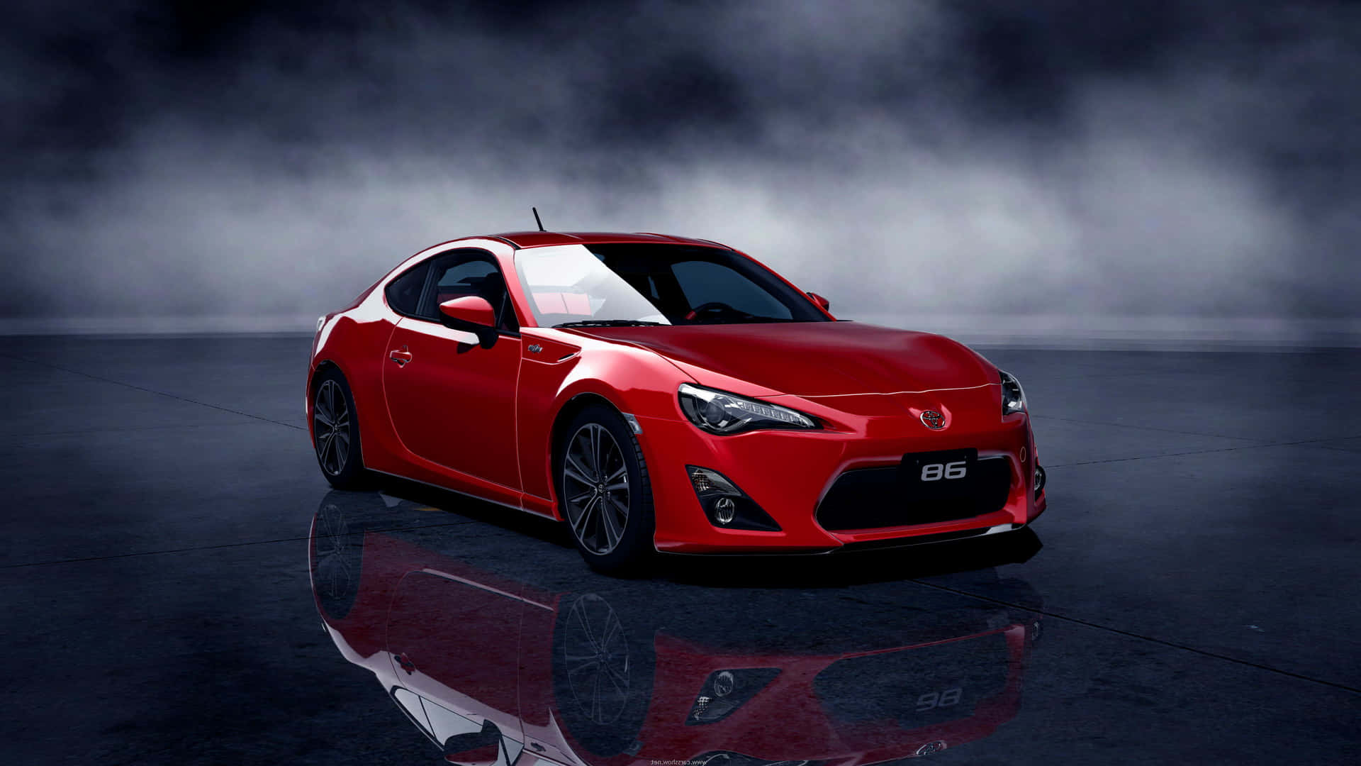 A Red Sports Car Is Shown In A Dark Room Wallpaper