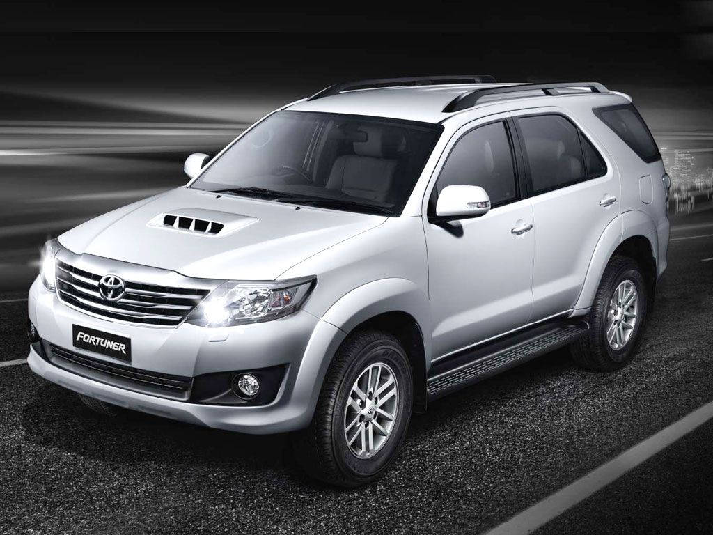 Caption: Silver 2012 Toyota Fortuner Parked On A Scenic Roadway Wallpaper