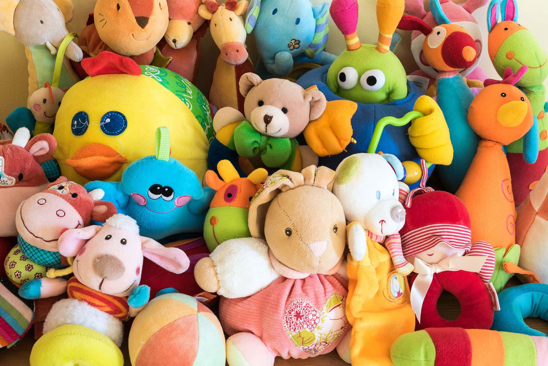 A Pile Of Stuffed Animals On A Shelf