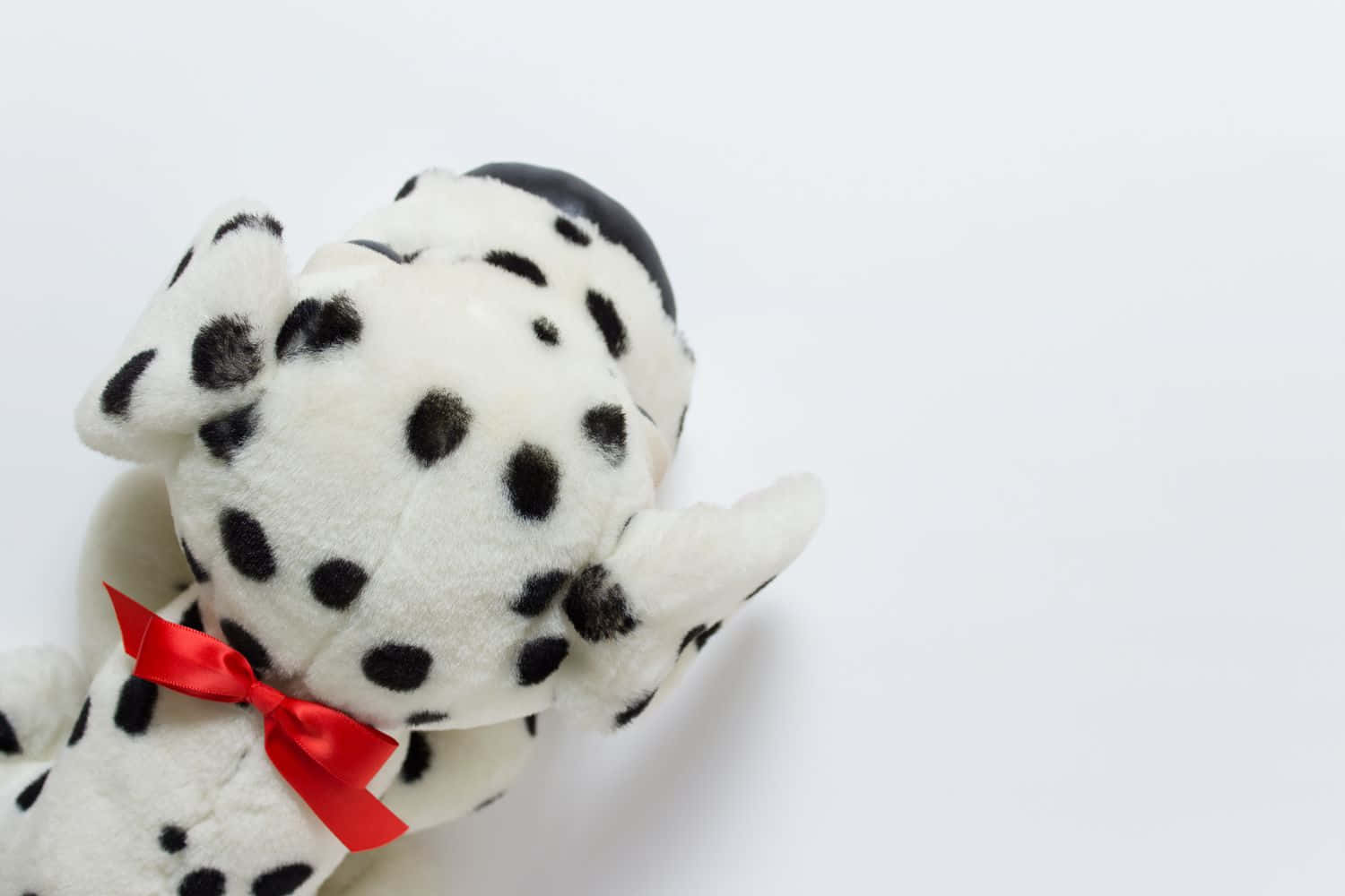 A Stuffed Dalmatian Dog With A Red Bow