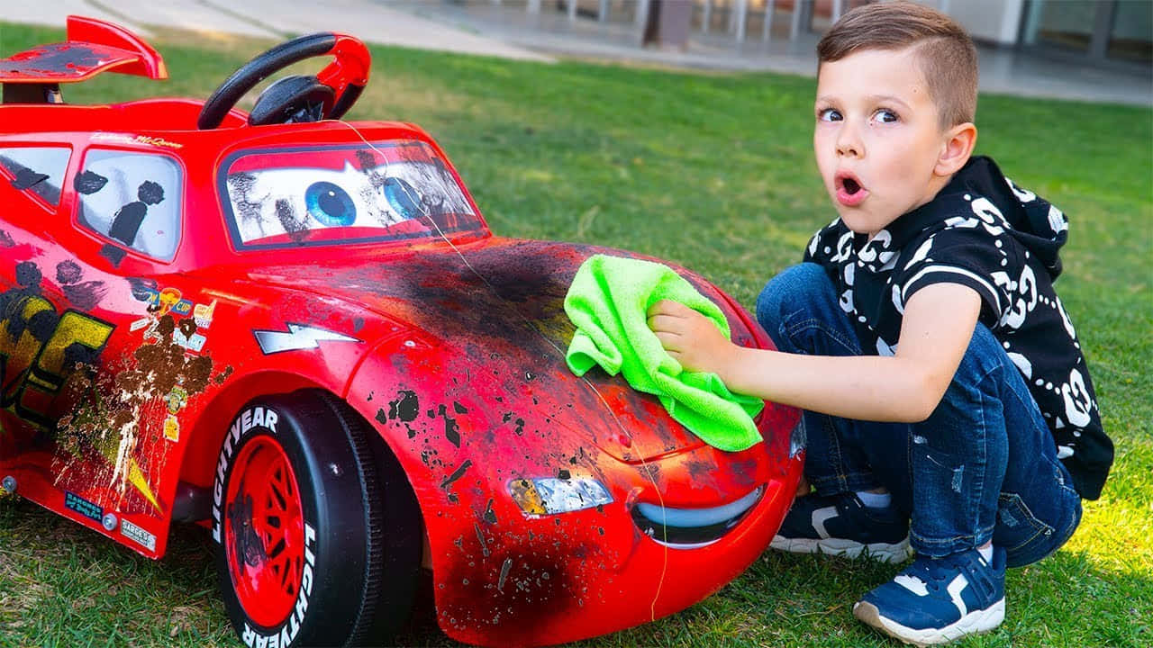 A Boy Is Cleaning Up His Toy Car