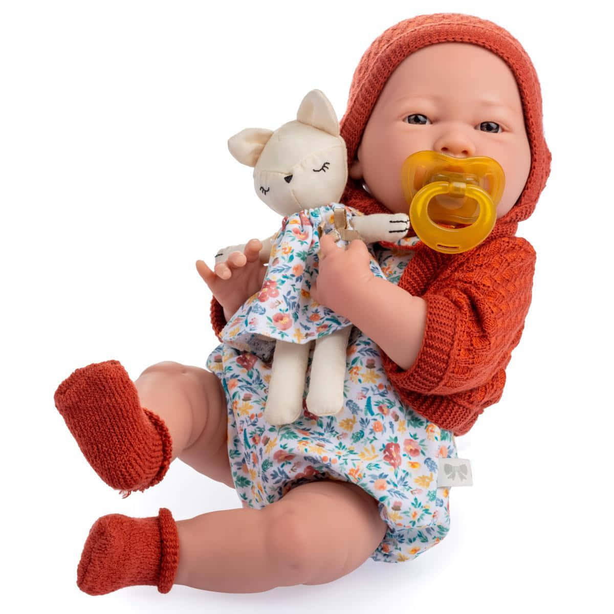 A Baby Doll With A Pacifier And A Stuffed Animal