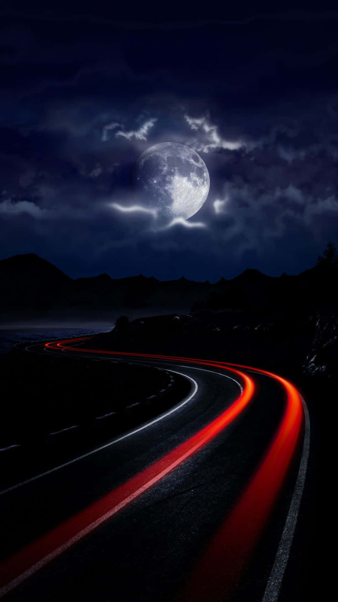 A Road With Red Lights And A Full Moon