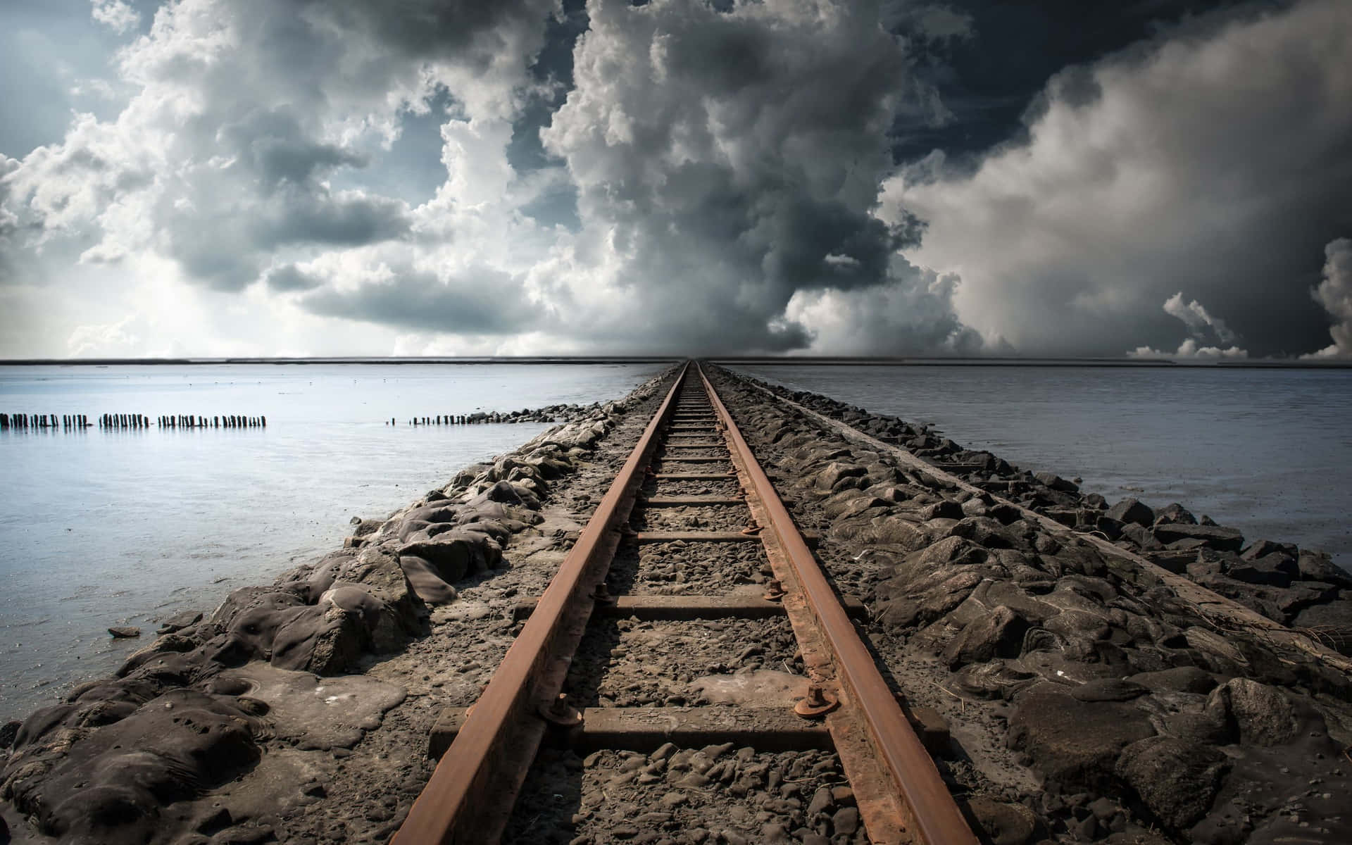 A Train Tracks Leading To The Ocean