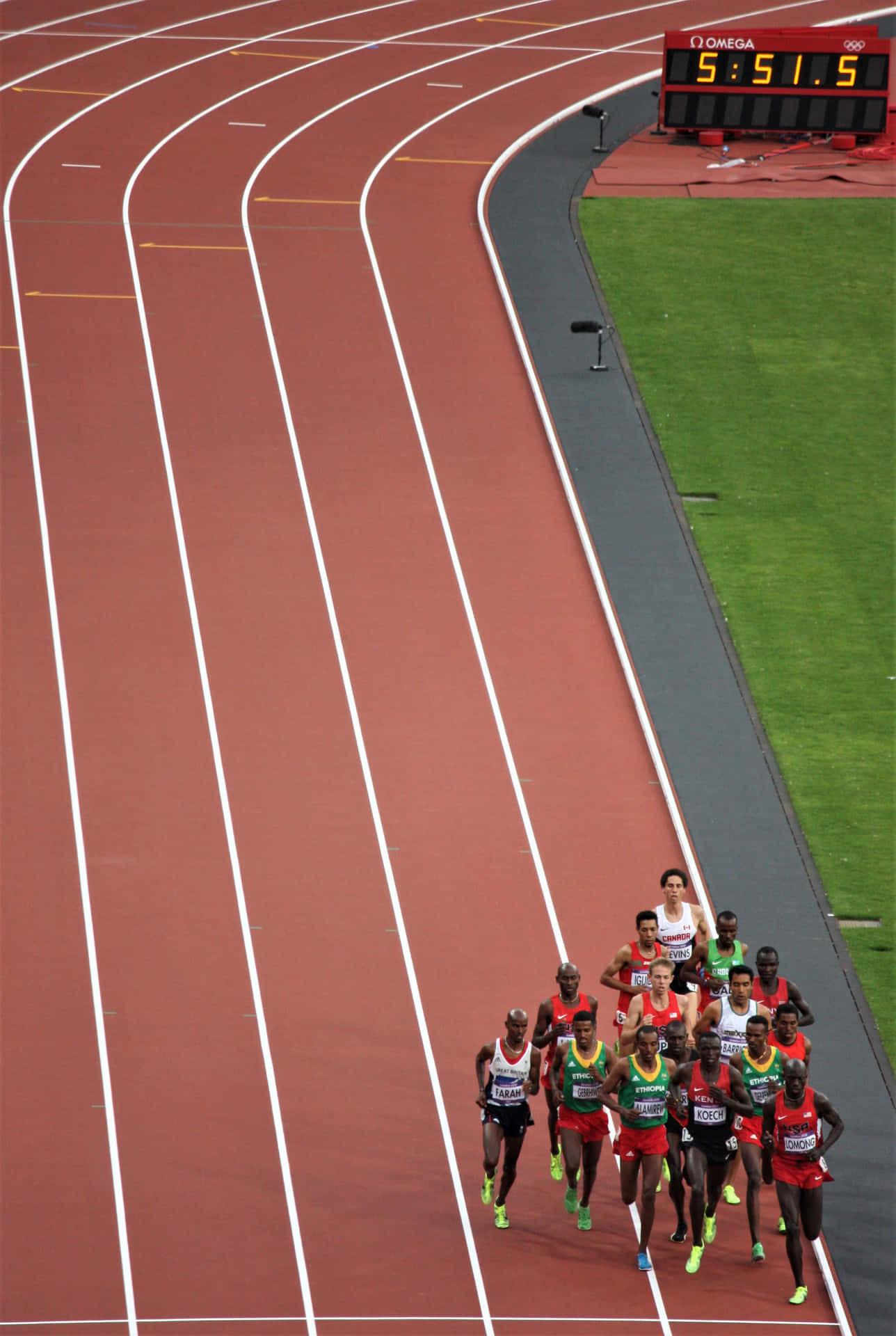 A Group Of People Running On A Track
